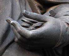 Statue of Commerce, detail of hand holding coins; 
photo © S. Alsford